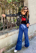 Cargar imagen en el visor de la galería, Jeans setenteros de mujer Flint, bota campana. Tejido algodón. Modelo bota Campana. Tiro alto. Cuatro bolsillos. Cierre de cremallera y botón. Diseño azul oscuro y Bordado Happy y smiling face en uno de los bolsillos traseros. Producto 100% hecho en Colombia. Compra online